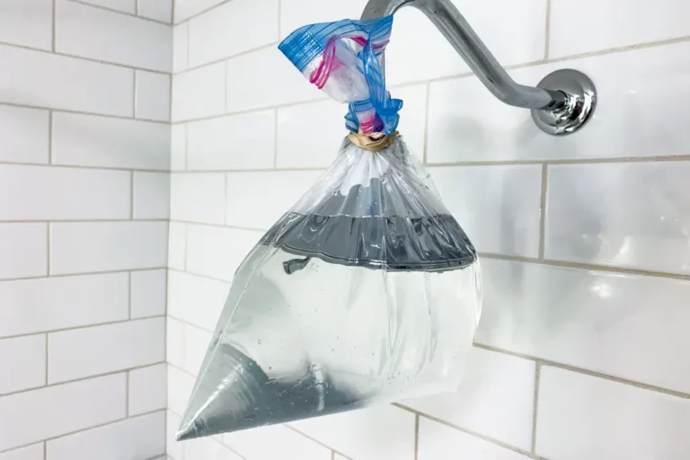 soaking shower head in vinegar to remove mineral buildup